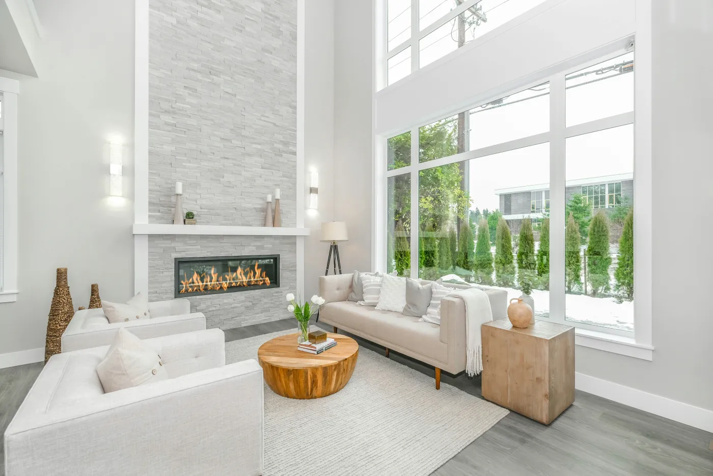 A bright living room with tall floor-to-ceiling windows
