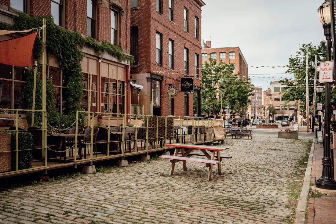 A cobblestone street in Portland's Old Port lined with brick storefronts